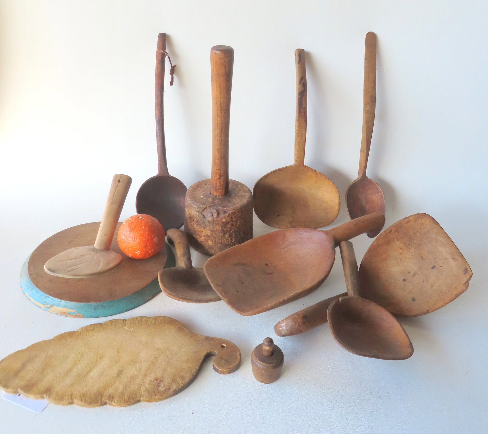 Grouping of early country treenware including a burlwood mallet, 2 serving ladles, 5 butter paddles: Grouping of early country treenware including a burlwood mallet, 2 serving ladles, 5 butter paddles including one with bird peak handle, and 1 small grain shovel. Most in very good condition, mid 19th