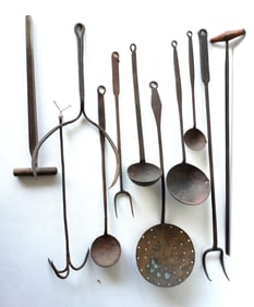 Grouping of 11 mostly hand forged iron kitchen tools including ladles, forks, pie lifter, strainer,