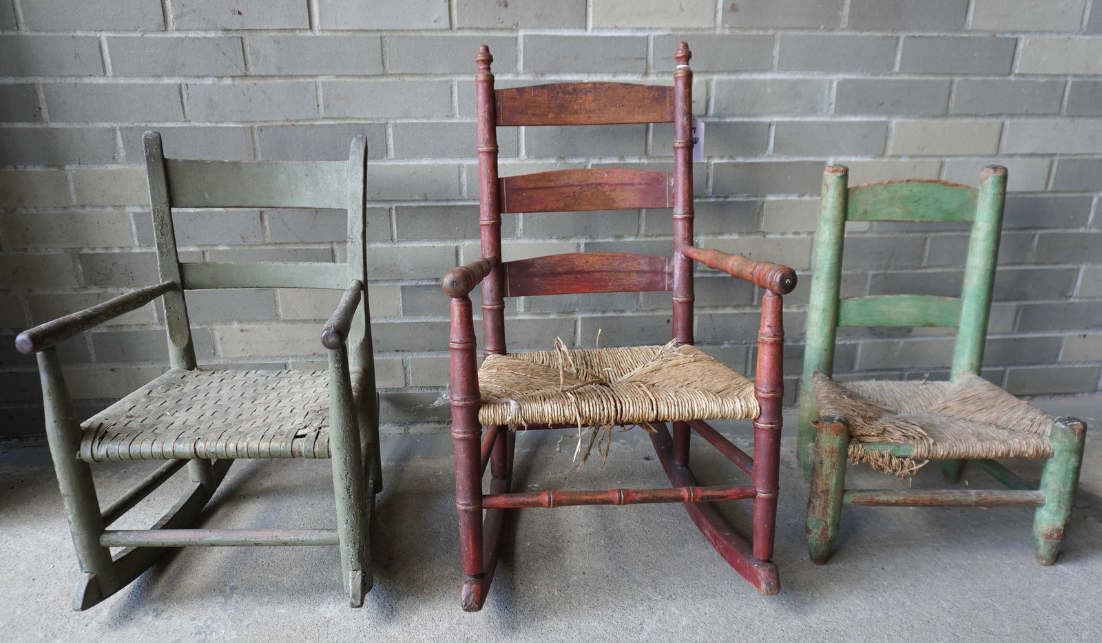 Three primitive child's chair/rockers, all in grungy old paint, 18th/19th century. All with use wear: Three primitive child's chair/rockers, all in grungy old paint, 18th/19th century. All with use wear but in stable condition - note the wear on the back stiles of the green child's chair where the chi