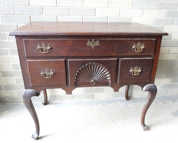 An American Centennial hand made Queen Ann style lowboy with duck feet, having a molded edge to top