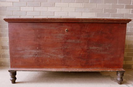A large blanket chest with turned feet and molded edge to lid.