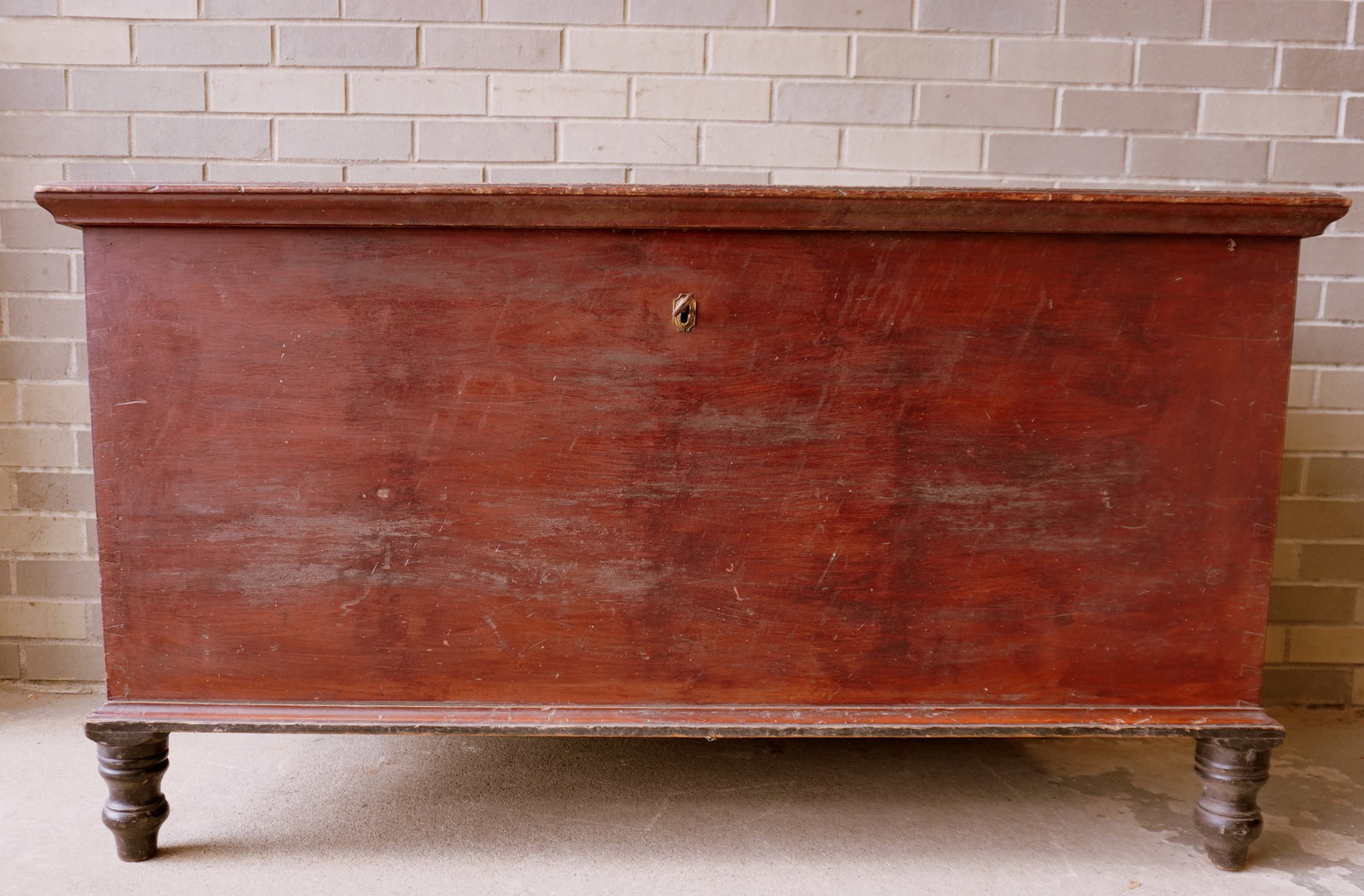 A large blanket chest with turned feet and molded edge to lid.: A large blanket chest with turned feet and molded edge to lid. Original red stain and original black paint on feet, dovetailed construction, circa 1850. Measures 50"L x 23 1/4"D x 27 3/4"H. Has one re