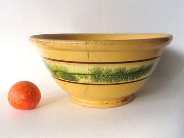 A large mochaware mixing bowl decorated with a wide band of blue seaweed, mid to late 19th century.