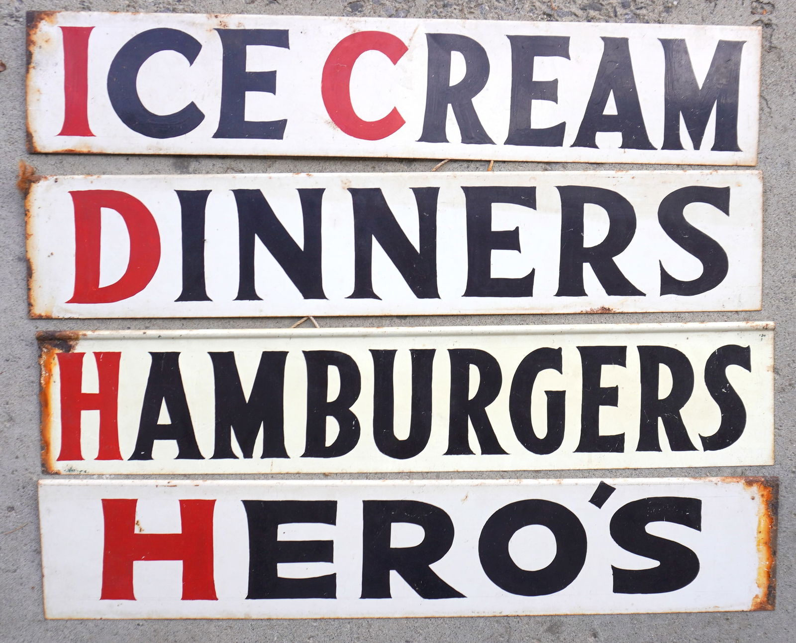 Grouping of 4 matching sheet metal country store restaurant signs in black and red on white ground,: Grouping of 4 matching sheet metal country store restaurant signs in black and red on white ground, minor rusting otherwise good condition. Includes "ICE CREAM", "DINNERS", "HAMBURGERS", and "HERO'S.