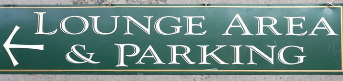 An aluminum sign marked "LOUNGE AREA & PARKING", circa 1970. Measures 60" x 12". Good condition.
