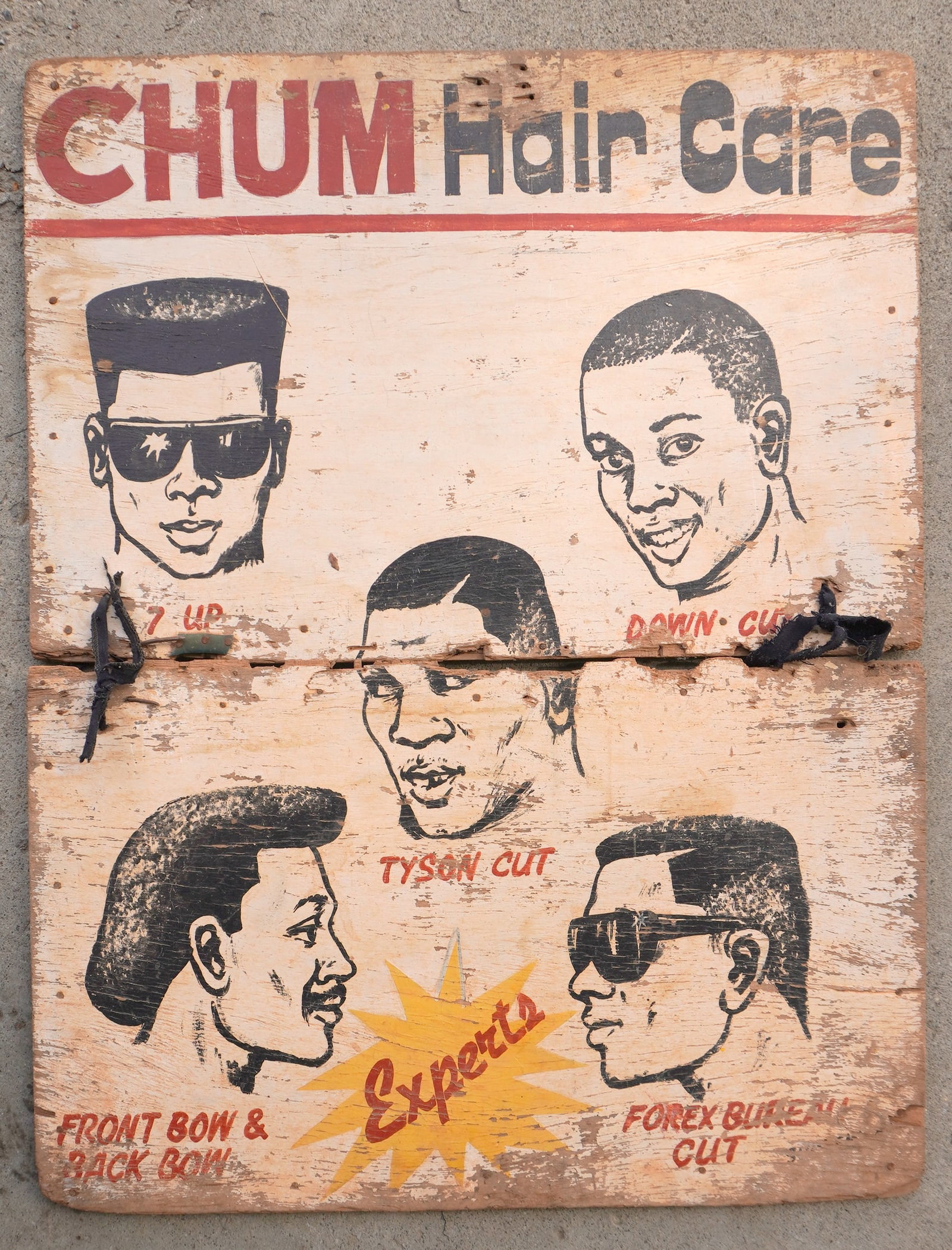 A folk art hand made 2 section African American barber shop sign, marked "CHUM HAIR CARE / EXPERTS": A folk art hand made 2 section African American barber shop sign, marked "CHUM HAIR CARE / EXPERTS" - with hand painted black, white and red figures, some celebrities including Mike Tyson in the cente