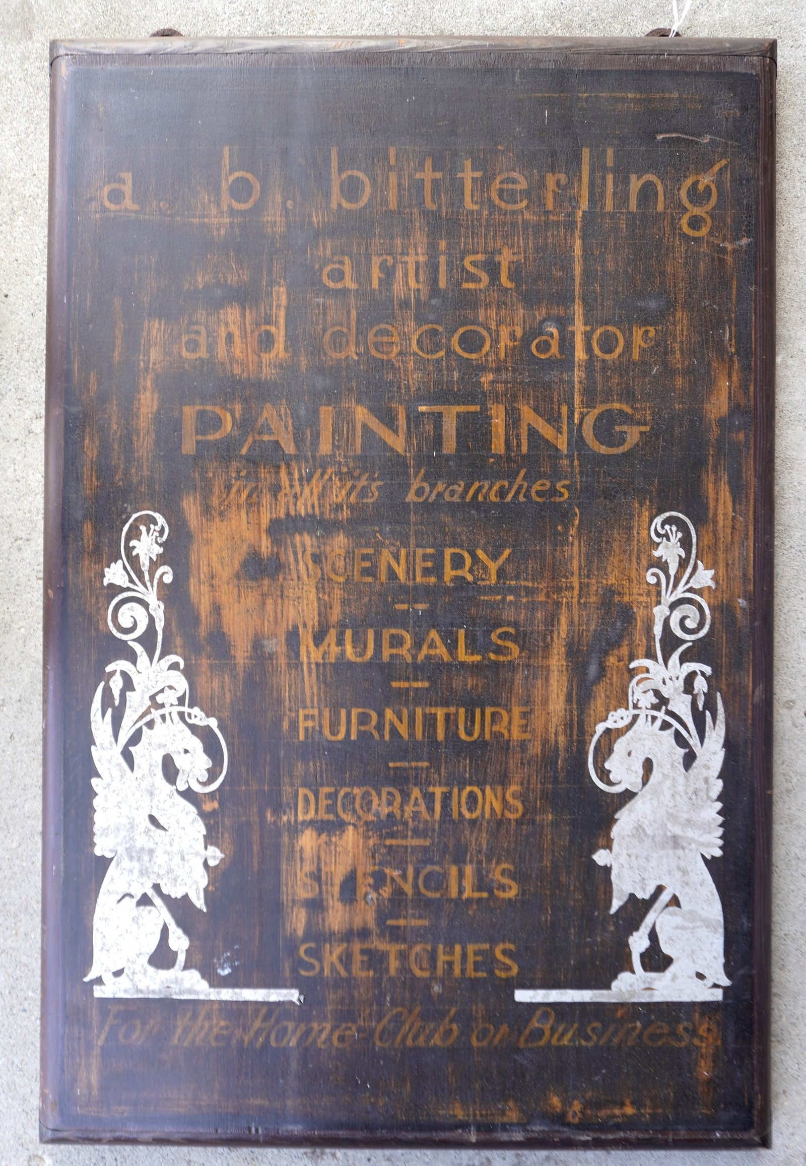 A heavy artist and decorator advertising sign in original paint with wear. Artist name "A.B.: A heavy artist and decorator advertising sign in original paint with wear. Artist name "A.B. Bitterling", circa 1930 - note the silver griffins on the sides flaking the advertising. Wear to paint but 