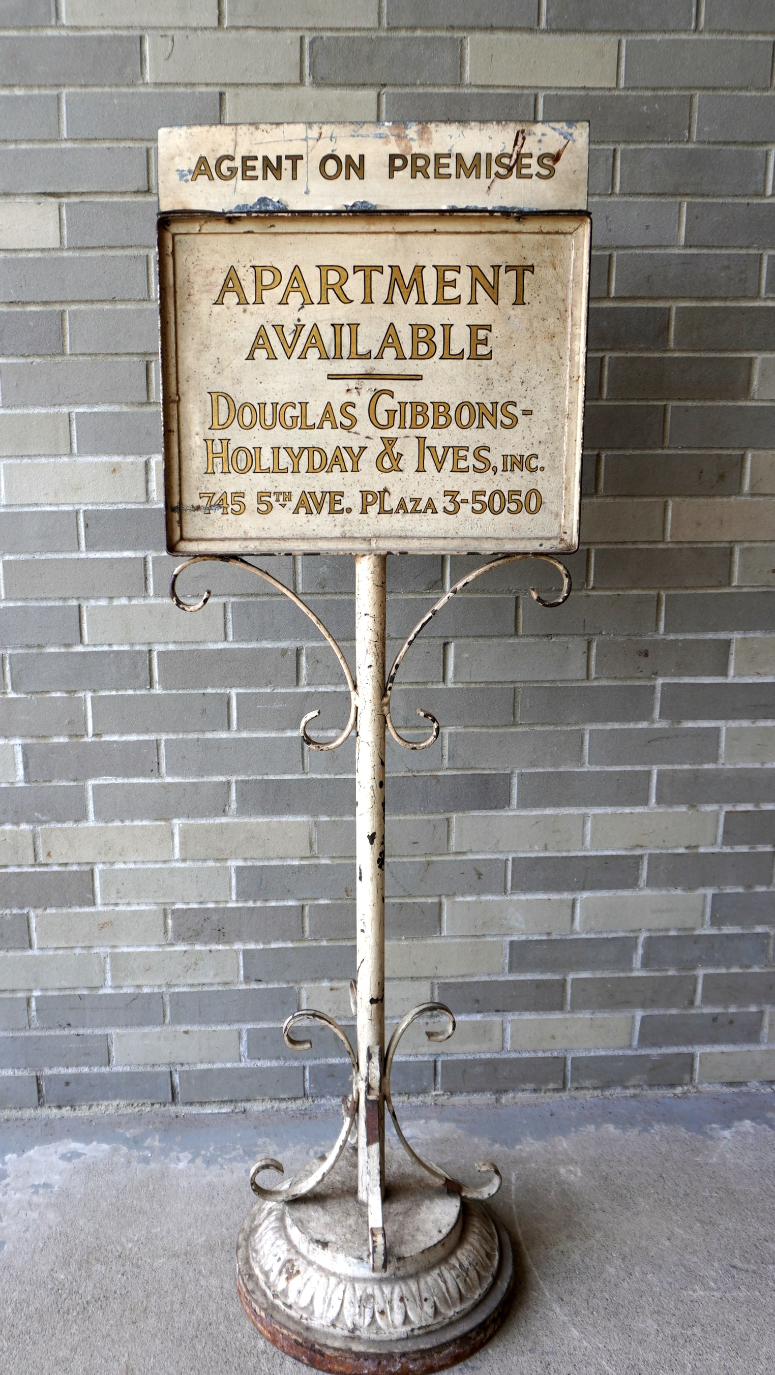 An original 1950-60's NY City double sided sheet iron floor standing real estate sign marked "AGENT: An original 1950-60's NY City double sided sheet iron floor standing real estate sign marked "AGENT ON PREMISES / APARTMENT AVAILABLE / DOUGLAS GIBBONS - HOLLYDAY & IVES, Inc. / 745 5th Ave. Plaza 3-5