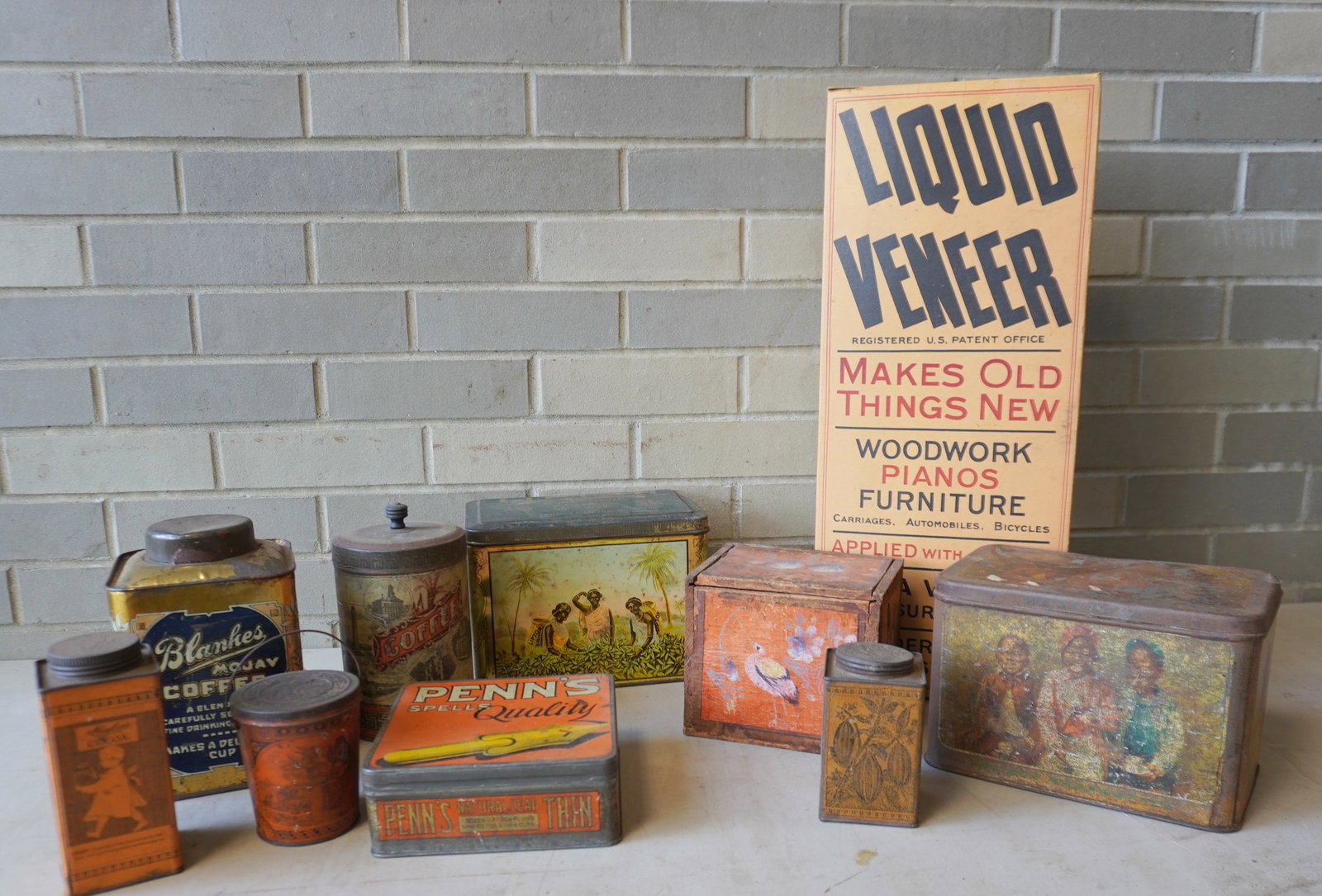 Grouping of 10 advertising tins, and boxes - the largest, the unused cardboard box of Liquid Veneers: Grouping of 10 advertising tins, and boxes - the largest, the unused cardboard box of Liquid Veneers - .50 cent - 8 1/4"W x 20"H. All with use wear but overall good condition. Provenance: From the Mar