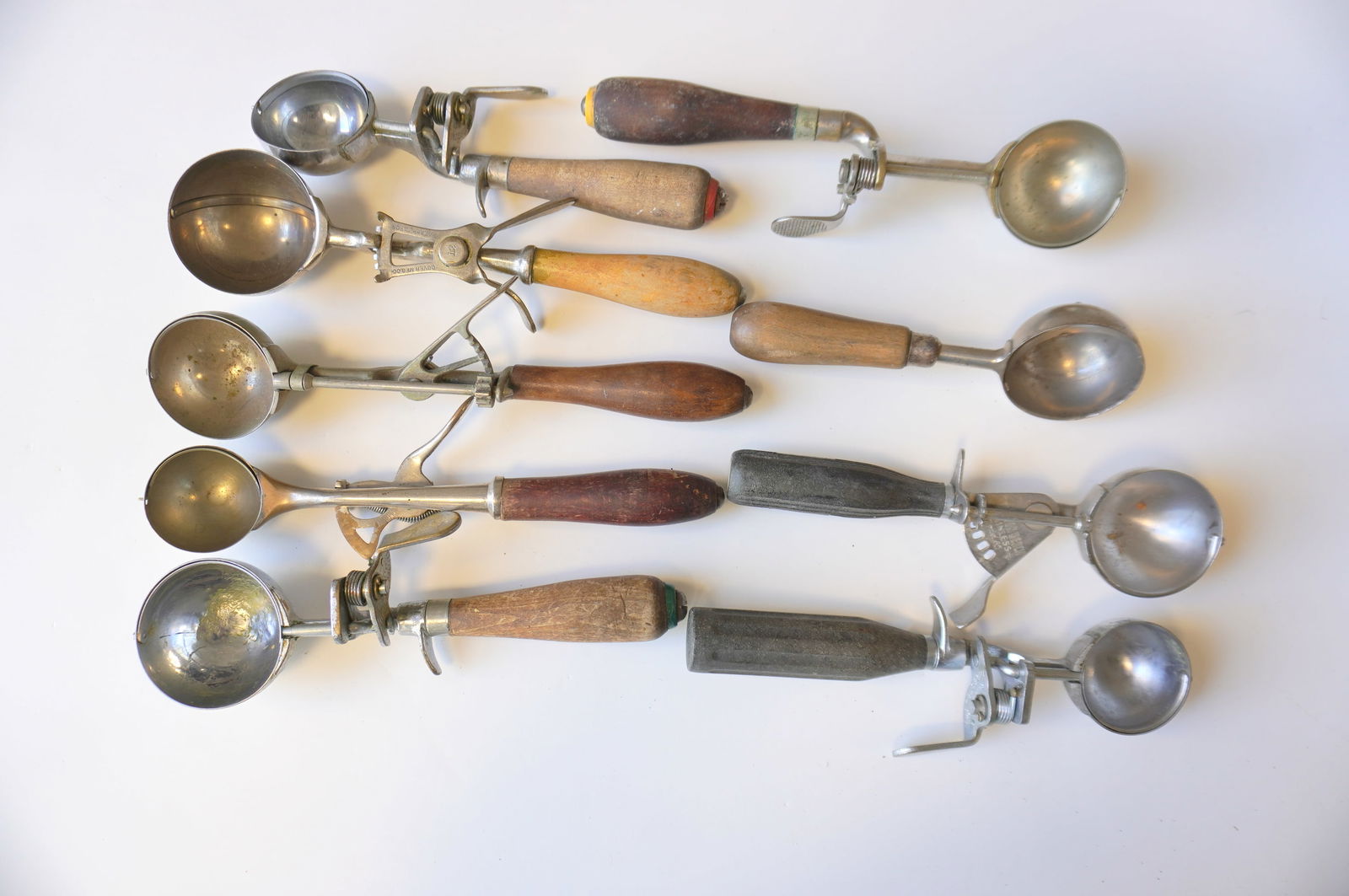 Grouping of 9 vintage ice cream scoops, all in in good working order - the largest measures 11"L.: Grouping of 9 vintage ice cream scoops, all in in good working order - the largest measures 11"L. Provenance: From the Marni Bakst and William Sadler collection of antiques, Verbank NY.