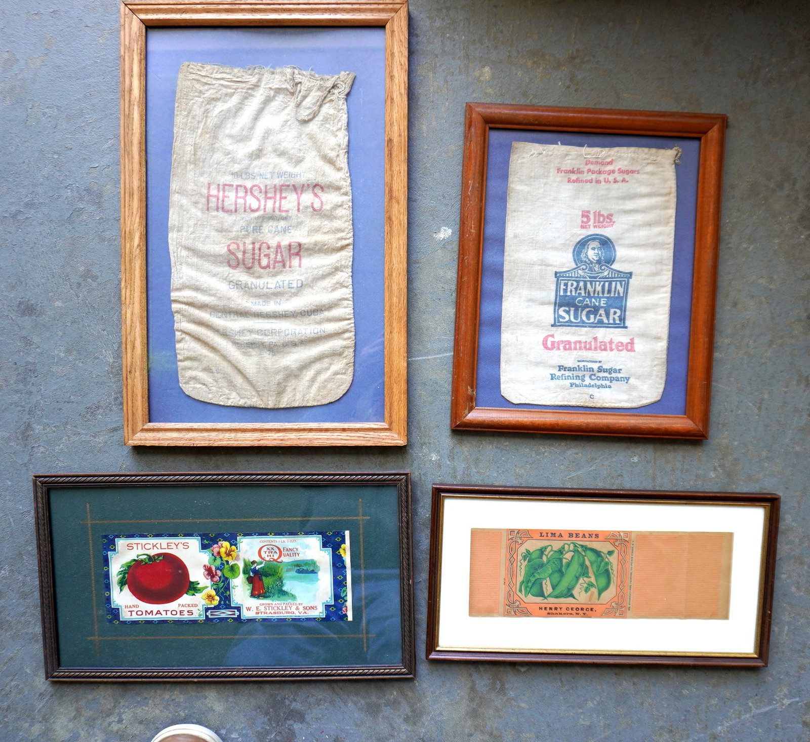 Grouping of 4 framed vintage advertising labels and sugar sacks, all in very good condition,: Grouping of 4 framed vintage advertising labels and sugar sacks, all in very good condition, including: Shaker label marked "Lima Beans / Henry George / Shakers, N.Y." - total frame size 15 3/4" x 8";
