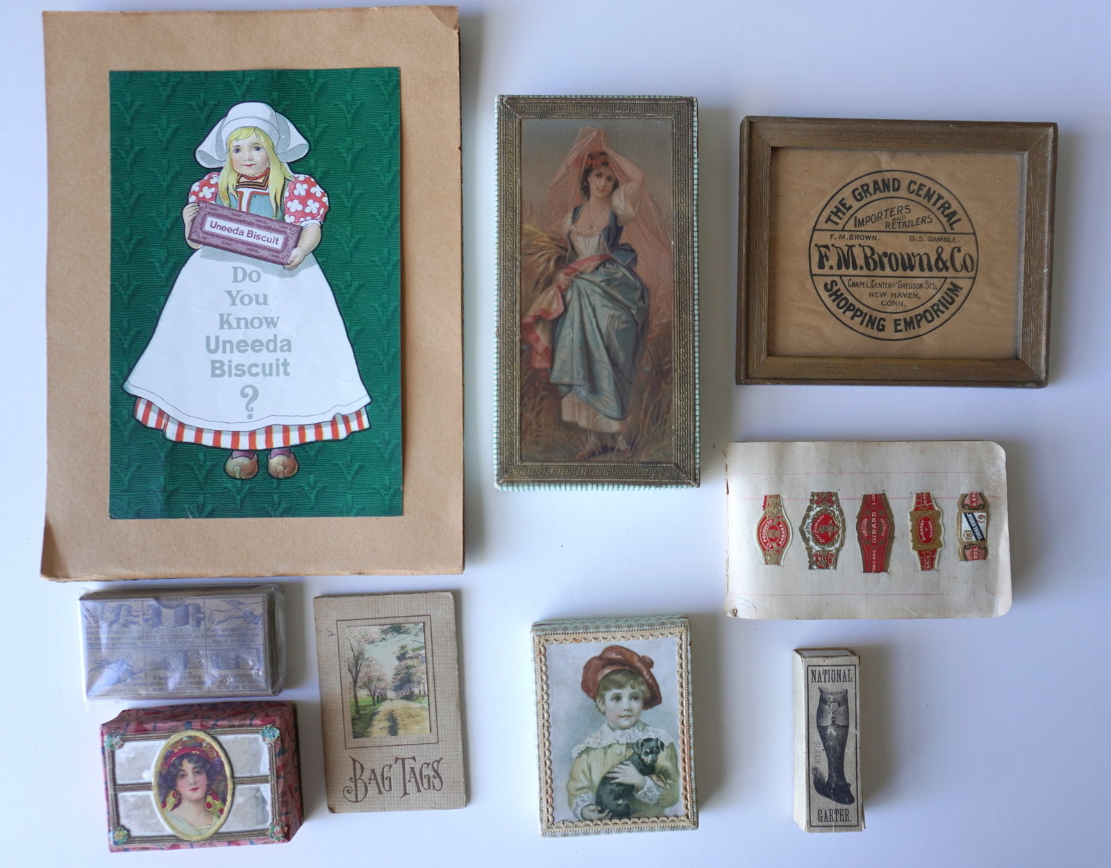 A grouping of advertising cardboard boxes and ephemera including a booklet containing cigar labels,: A grouping of advertising cardboard boxes and ephemera including a booklet containing cigar labels, Uneeda Basket advertising - this is the largest measuring 9" x 12 1/4", shipping bag tags in origina