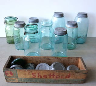 Grouping of 9 canning jars and extra lids, 19th and 20th century. Includes one in citrine color, 2