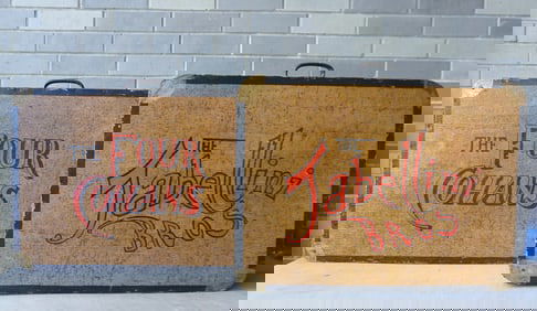 Two suitcase shaped wooden stage props, including "The Four Cohens" and "The Tabellini Bros." - both