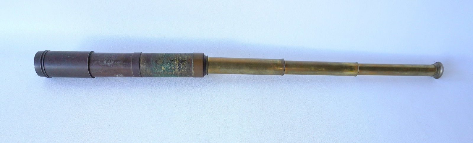A brass telescopic ship's spyglass, 19th century. Tarnished, missing end cap for lens, otherwise: A brass telescopic ship's spyglass, 19th century. Tarnished, missing end cap for lens, otherwise good condition in working order. Closed position measures 10 3/8"L and open position measures 31 1/2"L 
