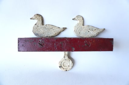 A Hoffman mechanical cast iron carnival shooting gallery target, 2 ducks above circular target with