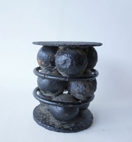 An iron Civil War grape shot with 9 ball held within 2 iron plates and 2 rings. Measures 5 1/4"H x 4