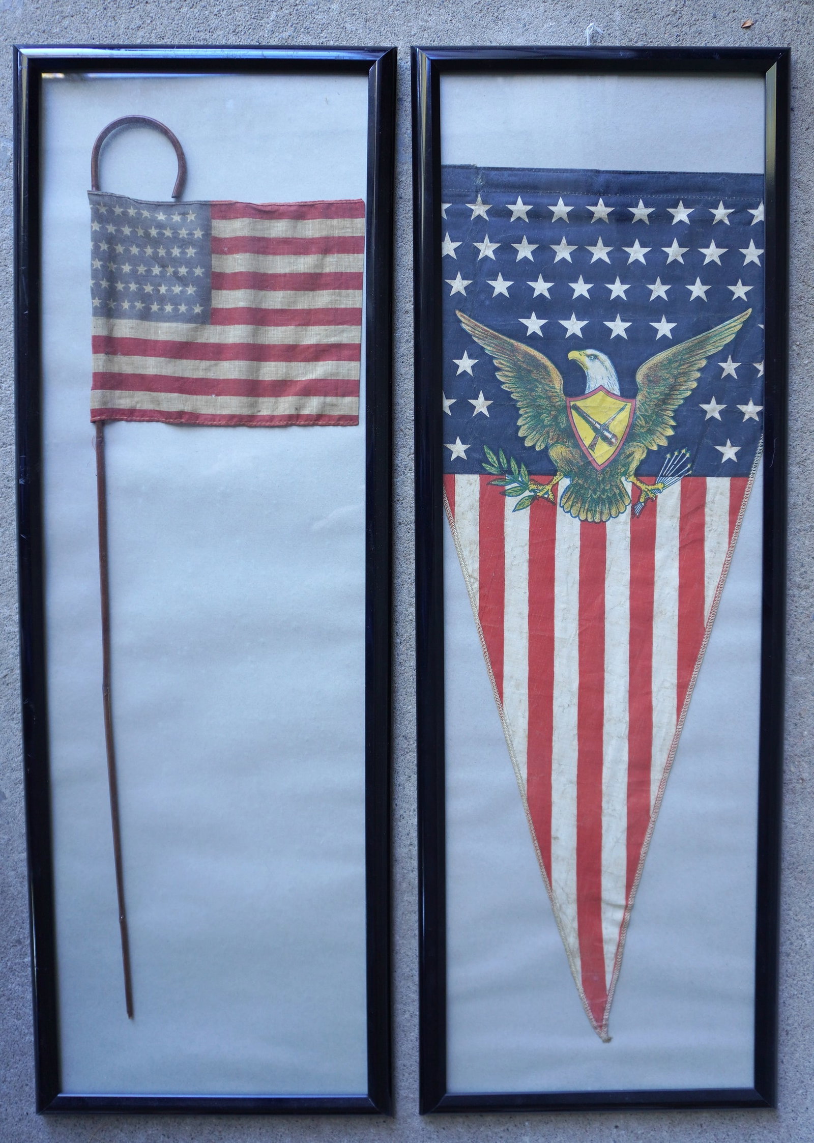A parade flag and pennant, both early to mid 20th century: A WWII 48 star pennant decorated with an: A parade flag and pennant, both early to mid 20th century: A WWII 48 star pennant decorated with an American spread wing eagle with cannon and rifle on shield - some soiling but overall very good cond
