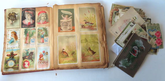 A Victorian scrap book dated 1887 plus a collection of 110 loose postcards, trade cards, holiday