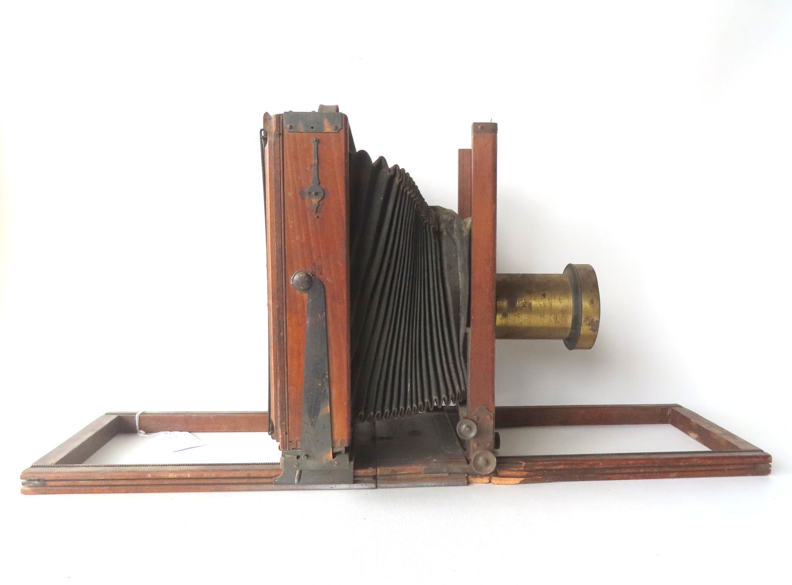 Wooden camera signed "Eastman View No. 1 / Improved Model of Century View and Empire State No. 1",: Wooden camera signed "Eastman View No. 1 / Improved Model of Century View and Empire State No. 1", with leather bellows and brass lens signed "Voightlander & John". Loss to end of wooden track on one