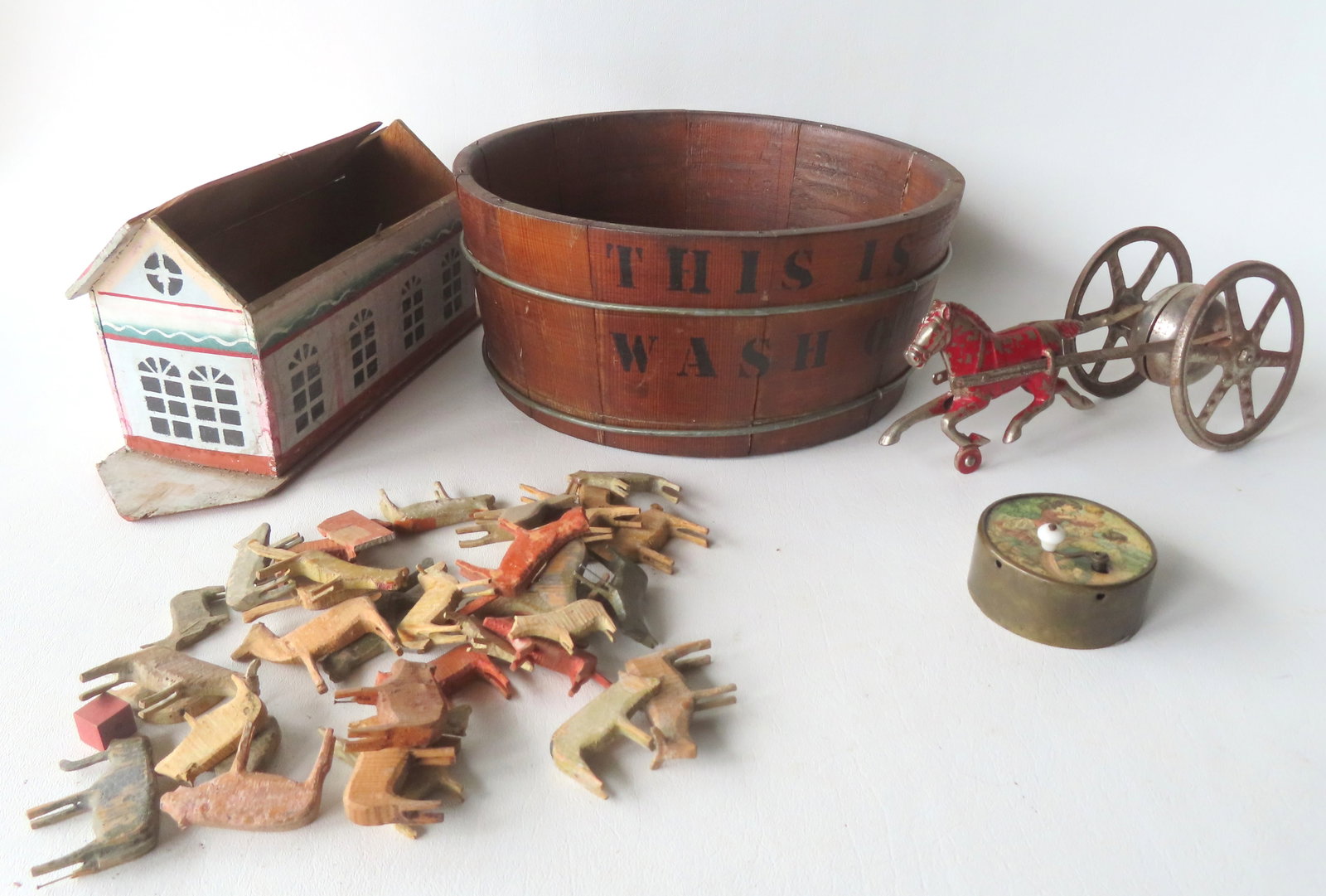 Grouping of 4 early toys including: Wooden staved washtub stenciled in black paint "THIS IS THE WAY: Grouping of 4 early toys including: Wooden staved washtub stenciled in black paint "THIS IS THE WAY WE WASH OUR CLOTHES", late 19th century - very good condition - measures 11 1/4" diameter x 4 7/8"H;