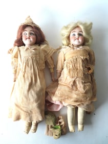 Two Victorian German bisque shoulder head dolls with kid bodies, both marked 154 DEP 6. The first,