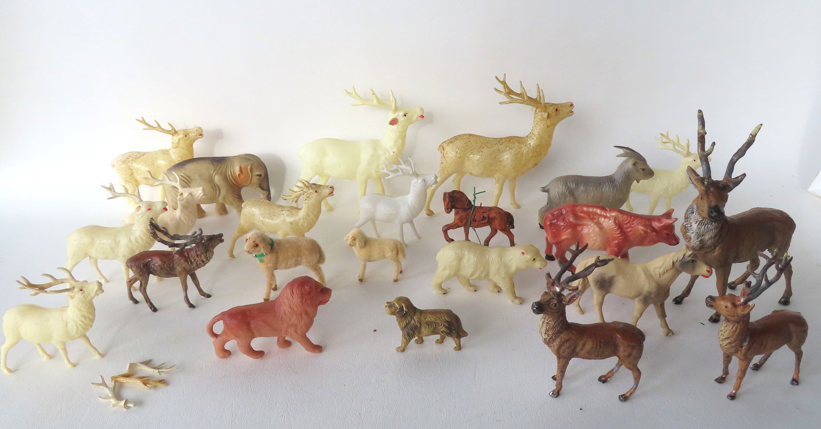 Grouping of figural animal ornaments, most Christmas related, including 16 in celluloid & plastic,: Grouping of figural animal ornaments, most Christmas related, including 16 in celluloid & plastic, composition horse, 2 miniature West German lambs, and 7 lead stags. Provenance: Handed down in family