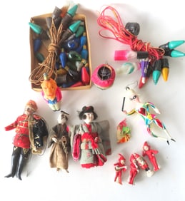 Grouping of Christmas related ornaments, bulbs, and dolls. Includes figural light bulbs including a