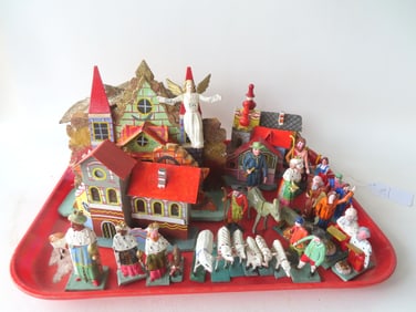 A hand made wooden Nativity scene with church, stable, and other buildings, animals, kings,