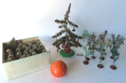 A grouping of miniature Christmas trees including: A small feather tree with red buds