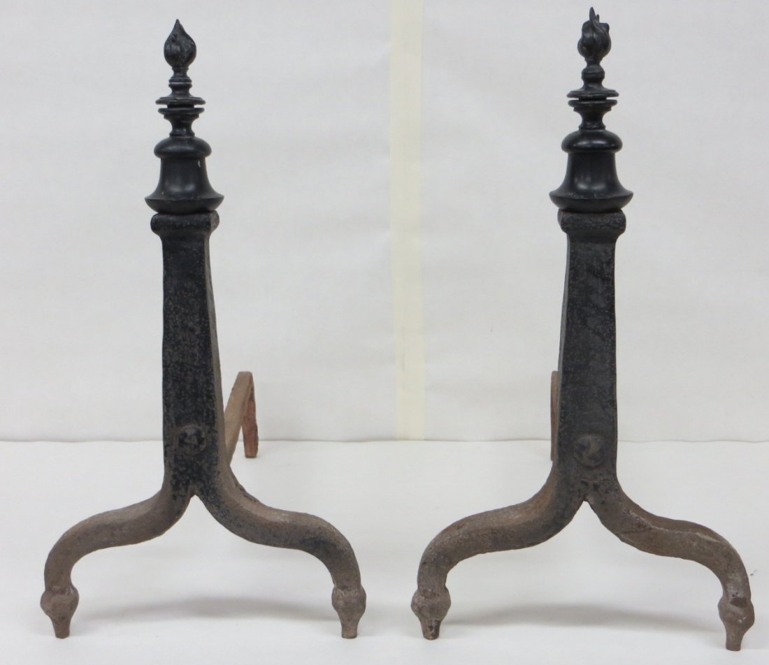 Pair of cast iron andirons with flame finials. 19.5"H: Pair of cast iron andirons with flame finials. 19.5"H