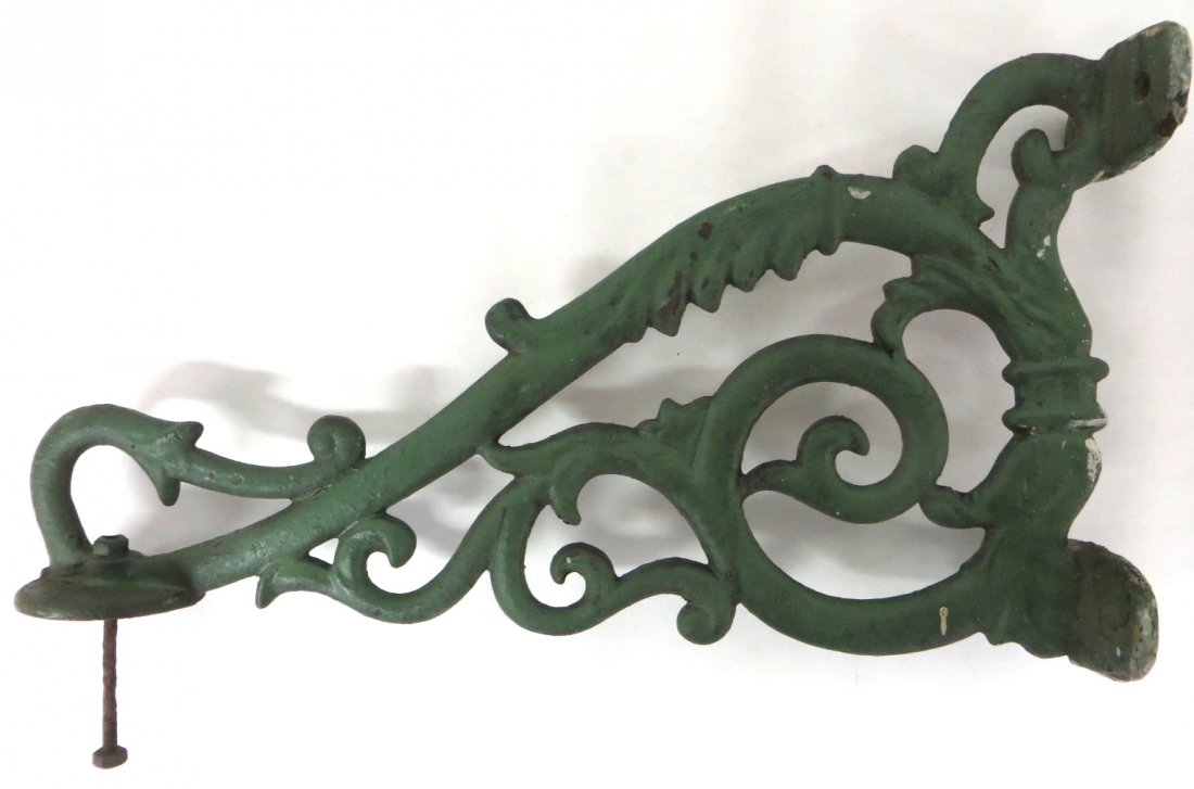 Large painted cast iron wall bracket, probably for hold: Large painted cast iron wall bracket, probably for holding a lighting device, 19th century - 18.25"L x 10.25"H.