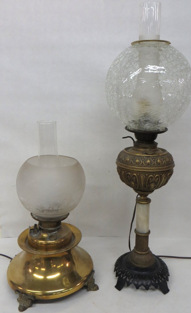 Two Victorian era table oil lamps including one with br: Two Victorian era table oil lamps including one with brass base and etched shade, the other iron base with marble column holding embossed brass font - shade on old crackle glass. Both have been electr
