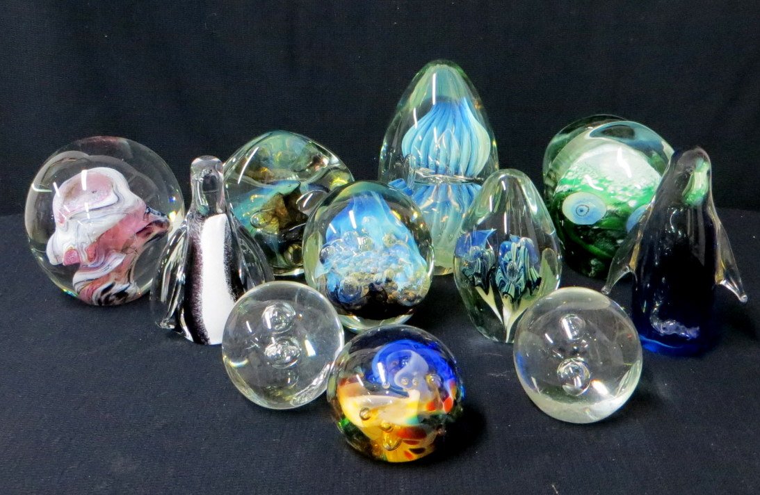 Eleven various glass paper weights including 2 penguins: Eleven various glass paper weights including 2 penguins, florals, etc. All believed to be mid to late 20th century. Provenance: From a large Beekman NY estate, name withheld by family.