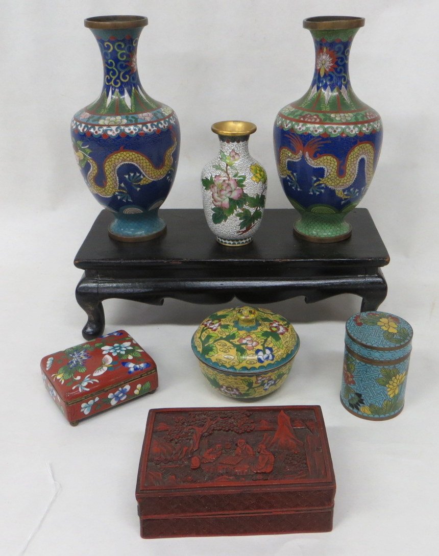Collection of 8 pieces of orientalia including 3 cloiso: Collection of 8 pieces of orientalia including 3 cloisonné vases (2 with dragon design), 3 cloisonné covered boxes, wooden oriental display platform, and a cinnabar box.