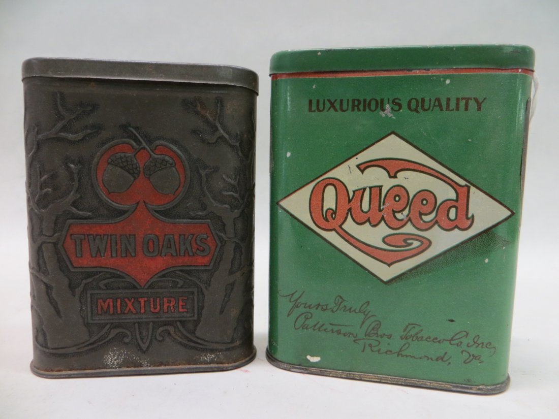 Two tobacco pocket tins including Twin Oaks Mixture and: Two tobacco pocket tins including Twin Oaks Mixture and Queed - 4" & 4.5"H. Provenance: From the Faulkner estate, New Kingston, NY.