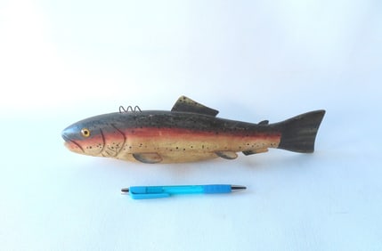 A large trout ice fishing decoy, hand carved and painted with glass eyes and tin fins, circa