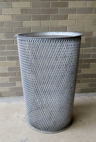 A large industrial cast iron mid-century waste basket with mesh body from the Dept. of Sanitation,