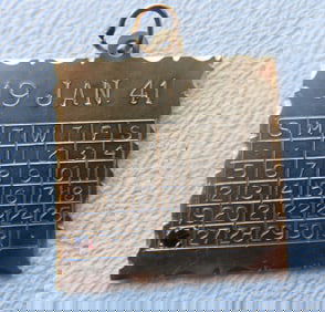 A marked 14k gold anniversary pendant/charm. One side with engraved calendar month of January marked