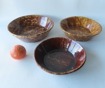 Three spongeware milk bowls, early to mid 19th century, various shades of brown an mustard, all in
