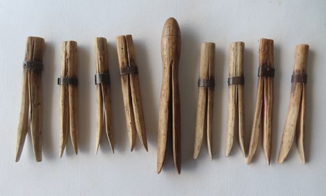 Grouping of 9 hand made wooden clothespins, circa mid 19th century, all in very good condition. The
