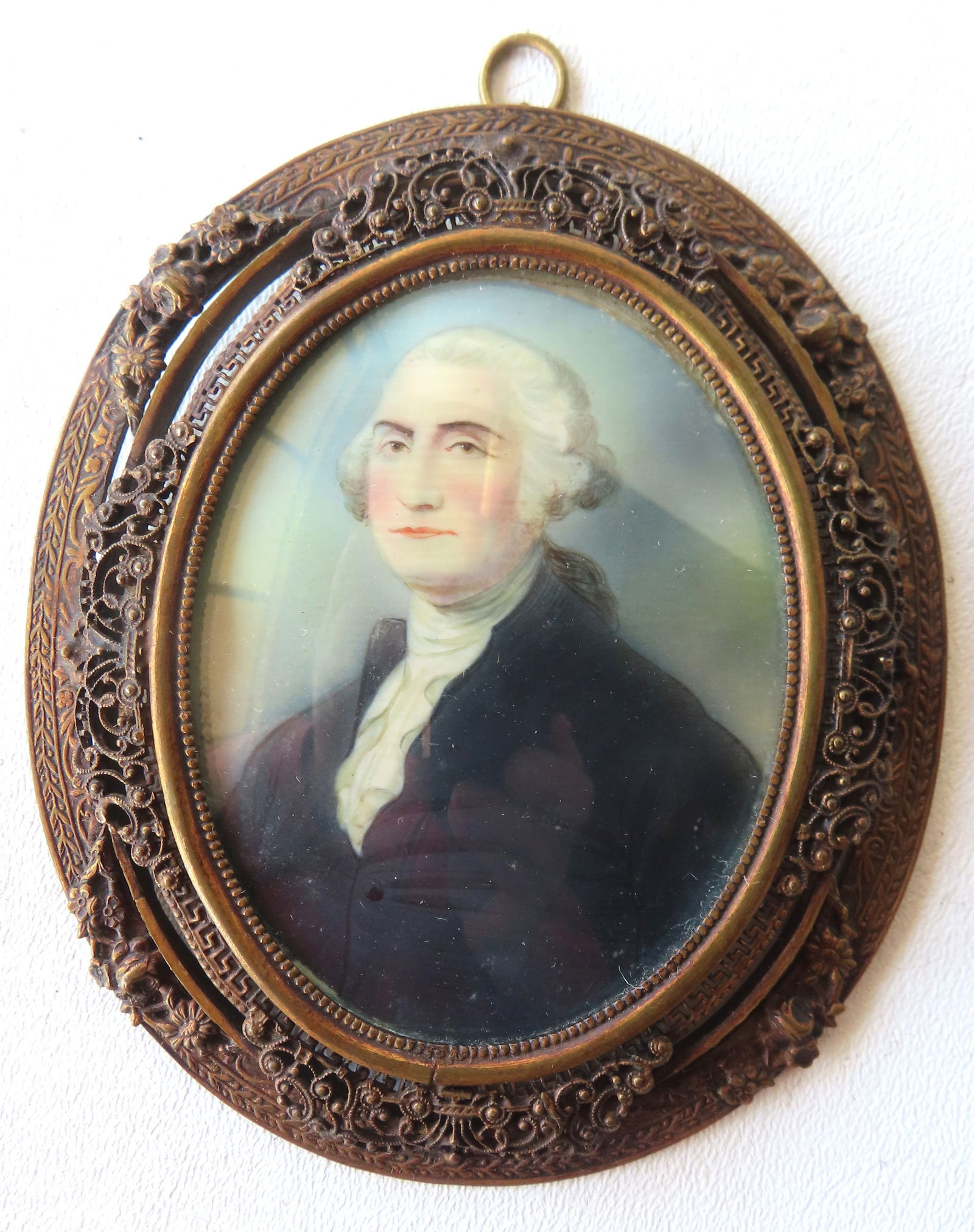 A miniature W/C portrait of George Washington in a fancy French style bronze frame, 19th century.: A miniature W/C portrait of George Washington in a fancy French style bronze frame, 19th century. Measures 4 7/8" x 2 1/8". Very good original condition. Provenance: From the Marni Bakst and William S