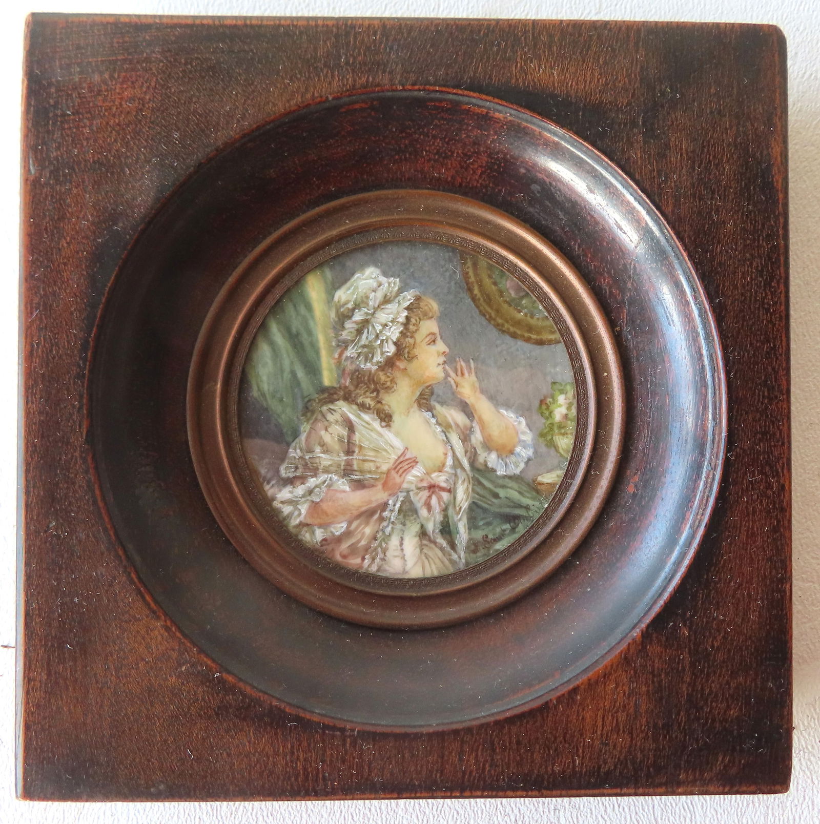 A miniature W/C portrait of a lady wearing night cap and gown, 19th century. Signed illegibly "Saint (1 of 5)