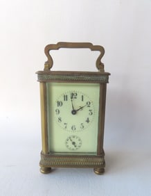 A French carriage clock with brass frame and beveled glass sides. No key so has not been tested.
