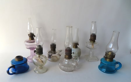 Grouping of 8 miniature oil lamps including 2 finger lamps in blue, 1 colorless marked "Little