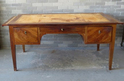 French directoire mahogany desk, having tapered legs, a tooled leather top over a narrow center