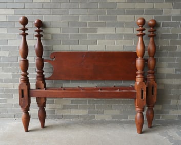 A country poster bed in original red stain with turned posts and cannon ball finials, early to mid