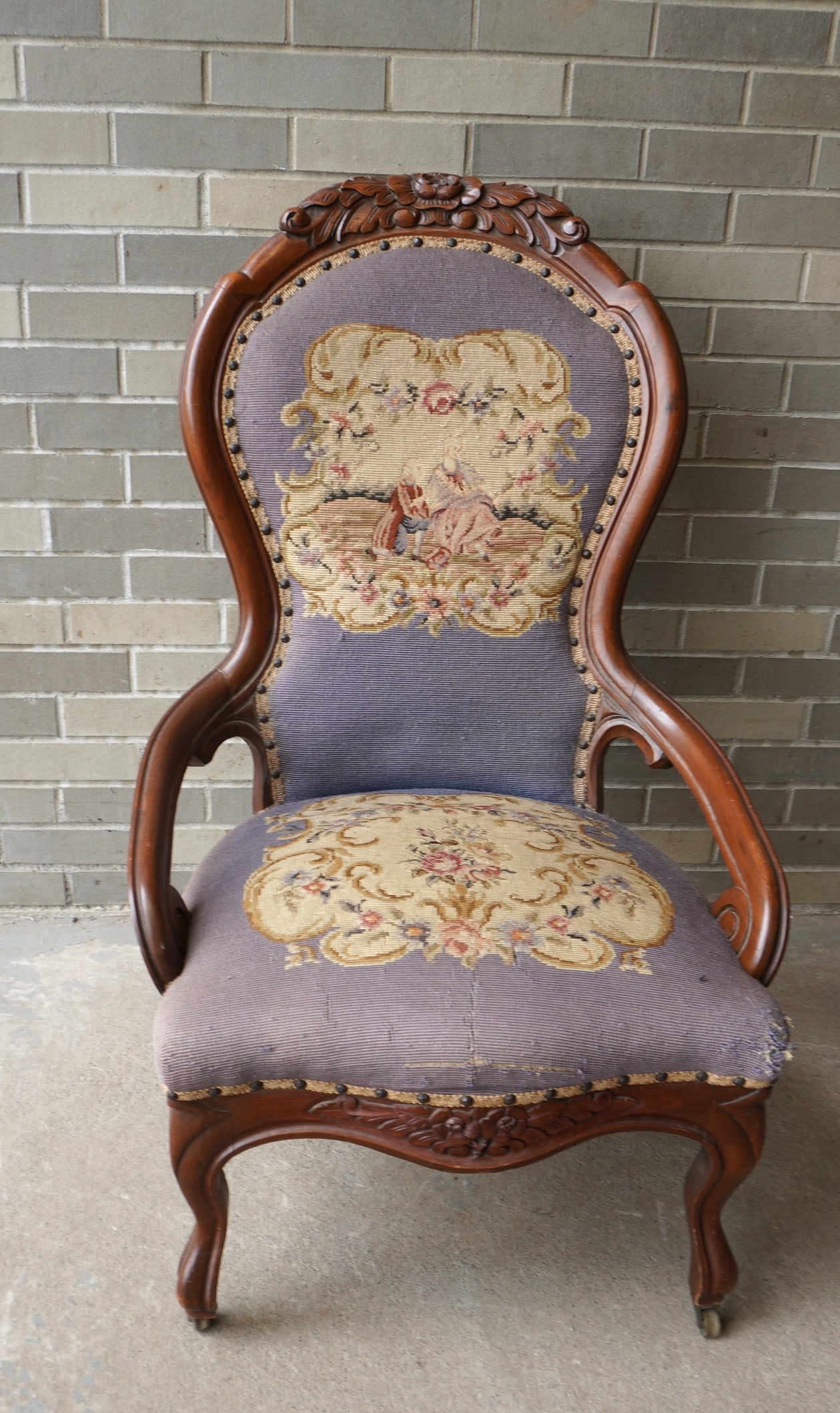 A Victorian black walnut lady's parlor chair with carved wooden frame and needlepoint and petit: A Victorian black walnut lady's parlor chair with carved wooden frame and needlepoint and petit point seats and back. Some minor losses to the needlepoint seat most noticeable across the front and in