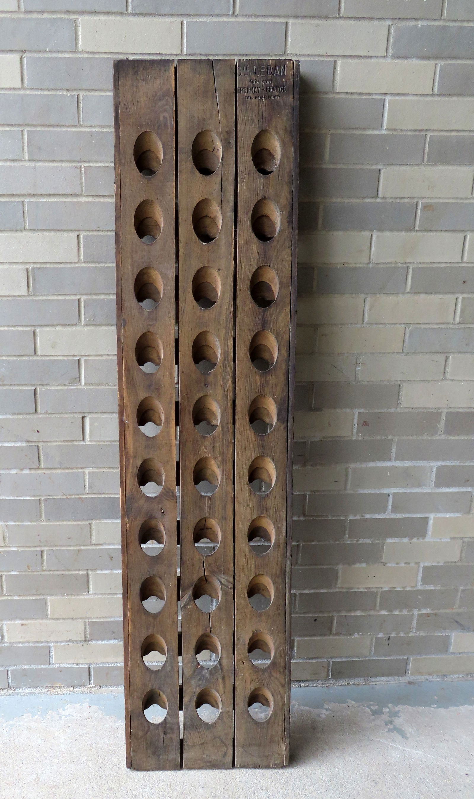A French wooden wine rack signed "Saint Lebon ….. Pernay France" - expansion cracks between: A French wooden wine rack signed "Saint Lebon ….. Pernay France" - expansion cracks between boards, but otherwise very solid and in good condition, original finish. Will hold 30 bottles. Measures 14