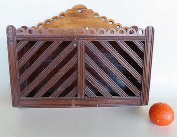 A hand made wooden country wall hanging magazine rack in original darkened varnish surface, late